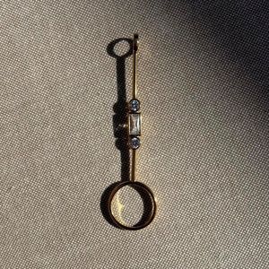 Gold cigarette holder/joint holder ring with crystal detail.